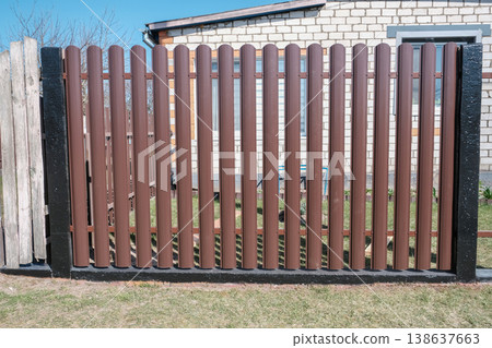 Modern brown metal euro fence panels home garden w section palisade picket with vertical slats and black posts Modern brown metal euro fence panels home garden w section palisade picket with vertical slats and black posts 138637663