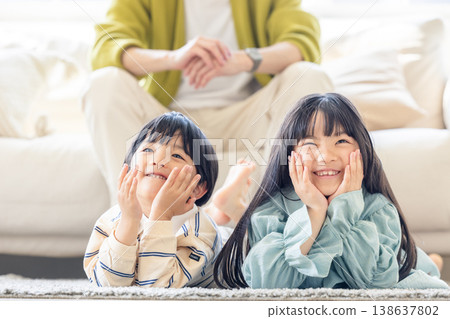 Parents and children relaxing in the living room Parents and children relaxing in the living room 138637802