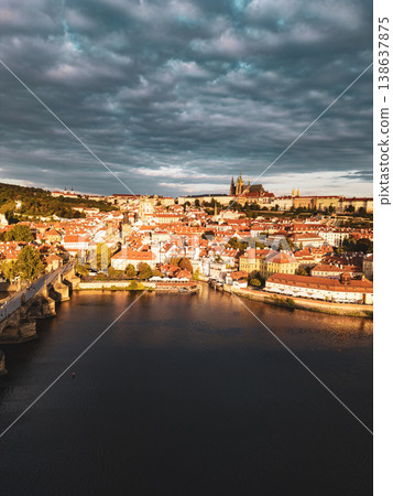 Early dawn reveals the stunning skyline of Prague, showcasing the historic Charles Bridge and the majestic Prague Castle. The calm Vltava River reflects the colors of the sky. Early dawn reveals the stunning skyline of Prague, showcasing the historic Charles Bridge and the majestic Prague Castle. The calm Vltava River reflects the colors of the sky. 138637875