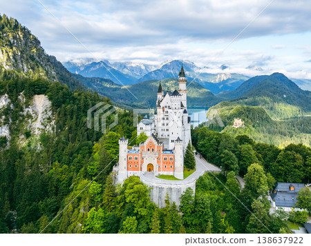 Nestled among lush greenery, Neuschwanstein Castle stands majestically against a backdrop of mountains and a serene lake. Visitors can enjoy breathtaking views and rich history. Nestled among lush greenery, Neuschwanstein Castle stands majestically against a backdrop of mountains and a serene lake. Visitors can enjoy breathtaking views and rich history. 138637922
