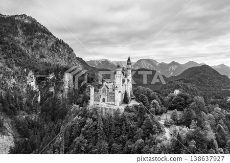 Perched on a rugged hill, Neuschwanstein Castle stands in majestic beauty against a backdrop of the Bavarian Alps. The architectural marvel invites wonder and intrigue as clouds drift overhead. Perched on a rugged hill, Neuschwanstein Castle stands in majestic beauty against a backdrop of the Bavarian Alps. The architectural marvel invites wonder and intrigue as clouds drift overhead. 138637927