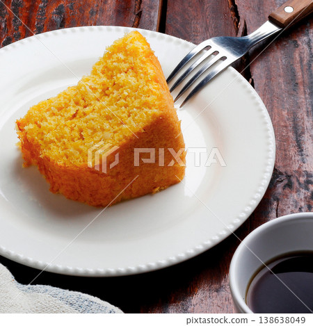 Corn Cake With Coconut white plate on rustic wooden table. Typical Brazilian party food. Corn Cake With Coconut white plate on rustic wooden table. Typical Brazilian party food. 138638049