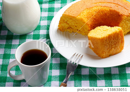 Corn Cake With Coconut white plate on rustic wooden table. Typical Brazilian party food. 138638051