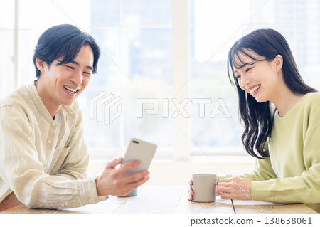 A couple looking at a smartphone A couple looking at a smartphone 138638061