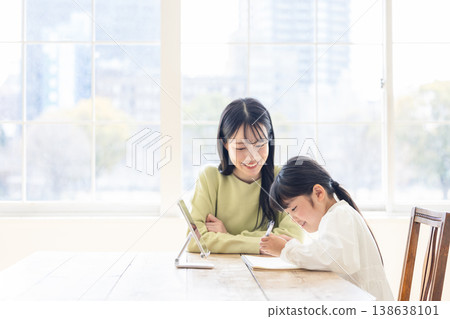 Parents and children studying in the living room 138638101