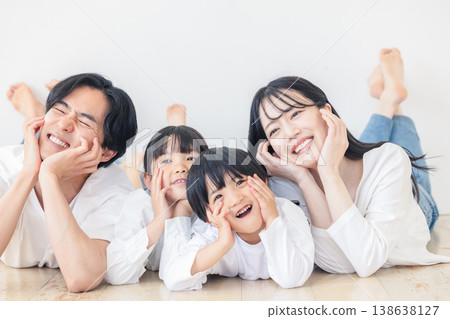 A young family resting their chin on their hand A young family resting their chin on their hand 138638127
