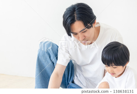 A father reading a picture book to his child A father reading a picture book to his child 138638131
