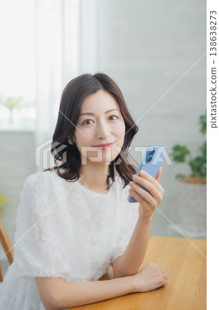 A woman watching a smartphone 138638273