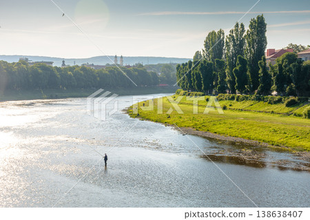 long embankment of the river Uzh in morning light. wonderful urban landscape in early summertime. gorgeous Transcarpathia capital observed from Tomas Masaryk bridge. serene eastern europe metropolis long embankment of the river Uzh in morning light. wonderful urban landscape in early summertime. gorgeous Transcarpathia capital observed from Tomas Masaryk bridge. serene eastern europe metropolis 138638407