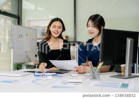 Asian people collaborate on project analysis with financial graphs. Strategic teamwork and insights drive company growth and success. Asian people collaborate on project analysis with financial graphs. Strategic teamwork and insights drive company growth and success. 138638832