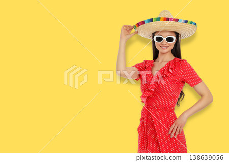 Woman wears a sombrero and red dress for Cinco de Mayo Woman wears a sombrero and red dress for Cinco de Mayo 138639056