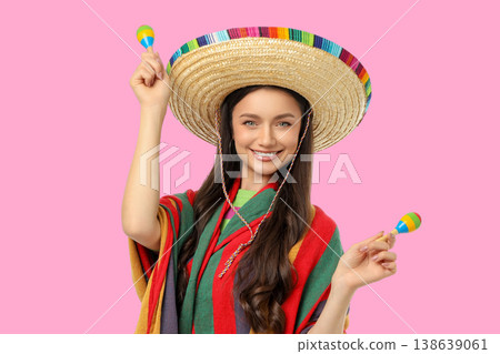 Young woman celebrates Cinco de Mayo with maracas Young woman celebrates Cinco de Mayo with maracas 138639061