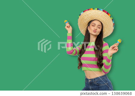 Cinco de Mayo, A young woman dances with maracas in a festive setting 138639068