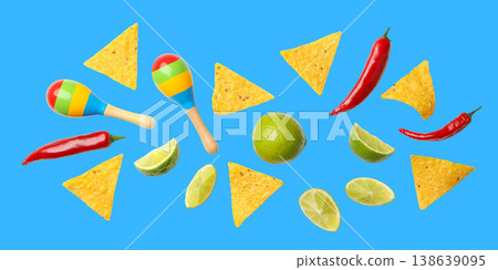 People enjoy nachos, chili, limes, and maracas for Cinco de Mayo People enjoy nachos, chili, limes, and maracas for Cinco de Mayo 138639095