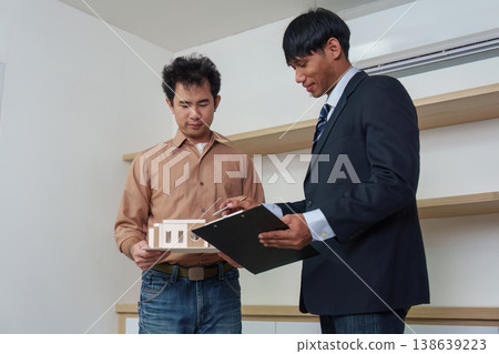 Real estate agent discussing property details with client 138639223