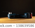 Sleek power tool Multi-cutter showcased on a wooden surface against a dark backdrop, emphasizing its design and functionality, copy space 138639586