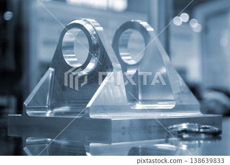 Metal part manufactured using CNC machining. Part made by metalworking CNC machine from metal. Polished aluminum or stainless steel. High-precision milling followed by polishing. Production technology 138639833