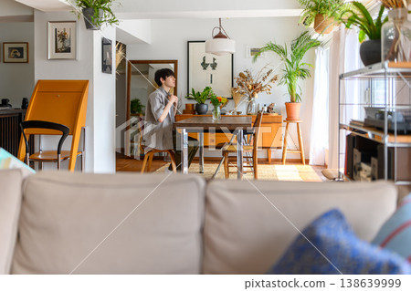 The profile of a young man thinking in the dining room The profile of a young man thinking in the dining room 138639999