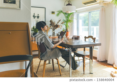 A young man reading a book indoors A young man reading a book indoors 138640004