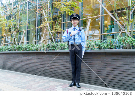 A young Japanese male security guard places his hand on his chest. Photo courtesy of Denpa Gakuen Educational Foundation, Tokyo Electronics College. A young Japanese male security guard places his hand on his chest. Photo courtesy of Denpa Gakuen Educational Foundation, Tokyo Electronics College. 138640108