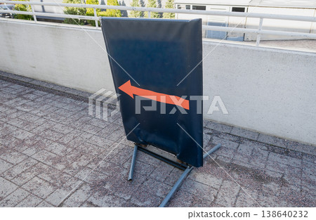 Directional arrow sign pointing left on black board urban navigation guidance concept 138640232