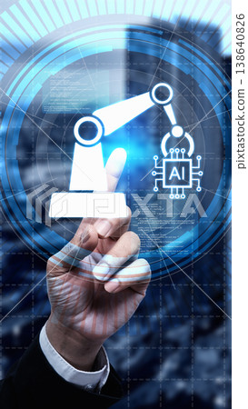 Hand pointing at a digital interface showing a robotic arm and AI chip icon, representing futuristic automation, artificial intelligence, and smart manufacturing technology in a corporate setting Hand pointing at a digital interface showing a robotic arm and AI chip icon, representing futuristic automation, artificial intelligence, and smart manufacturing technology in a corporate setting 138640826