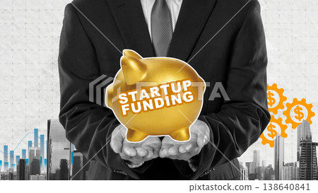 Conceptual collage of a businessman holding a piggy bank labeled Startup Funding against a city background with financial charts and dollar sign gears Conceptual collage of a businessman holding a piggy bank labeled Startup Funding against a city background with financial charts and dollar sign gears 138640841
