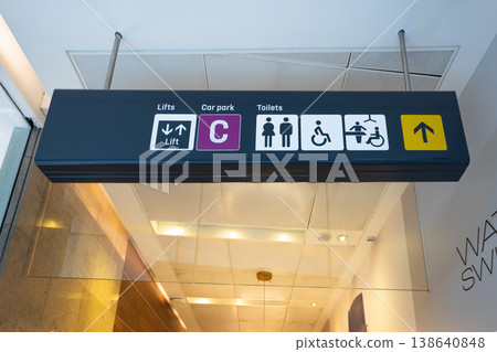 Overhead directional sign for restrooms and elevator 138640848
