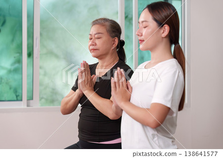 Meditative yoga session with senior and trainer Meditative yoga session with senior and trainer 138641577