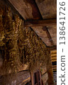 Dried herbs are hung on wooden beams in an old space for preservation during a late afternoon 138641726