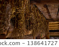 Dried herbs are hung on wooden beams in an old space for preservation during a late afternoon 138641727