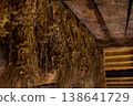 Dried herbs are hung on wooden beams in an old space for preservation during a late afternoon 138641729
