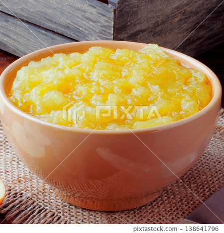 homemade apple sauce or apple puree in ceramic bowl over rustic wooden table. top view 138641796