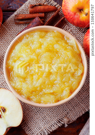 homemade apple sauce or apple puree in ceramic bowl over rustic wooden table. top view homemade apple sauce or apple puree in ceramic bowl over rustic wooden table. top view 138641797