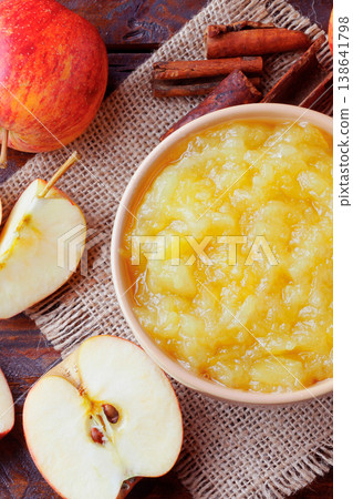 homemade apple sauce or apple puree in ceramic bowl over rustic wooden table. top view homemade apple sauce or apple puree in ceramic bowl over rustic wooden table. top view 138641798