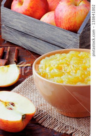 homemade apple sauce or apple puree in ceramic bowl over rustic wooden table. top view 138641802