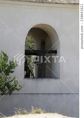 A fragment of an arched bell tower window. A fragment of an arched bell tower window. 138641821