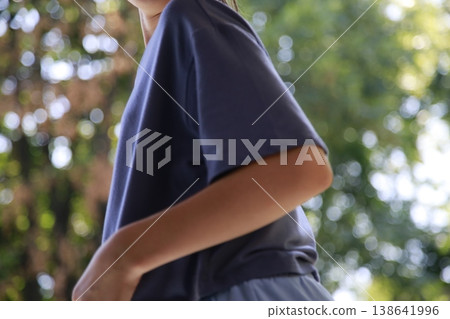 A girl in a blue t-shirt in nature. A girl in a blue t-shirt in nature. 138641996