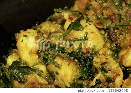 Close up of home made spicy Bombay potatoes with spinach Indian snack dish Close up of home made spicy Bombay potatoes with spinach Indian snack dish 138642008