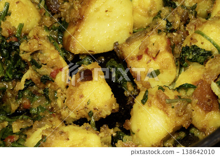 Close up of home made spicy Bombay potatoes with spinach Indian snack dish Close up of home made spicy Bombay potatoes with spinach Indian snack dish 138642010