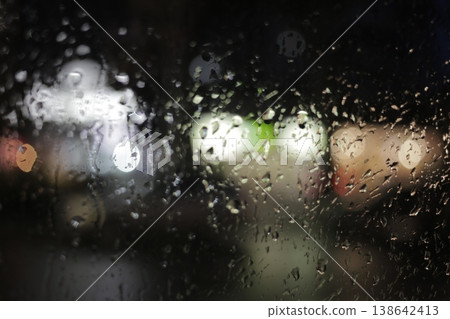 Close-up of raindrops on a window pane. Close-up of raindrops on a window pane. 138642413