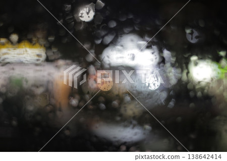 Close-up of raindrops on a window pane. Close-up of raindrops on a window pane. 138642414