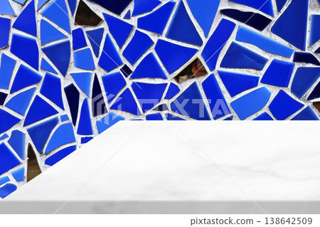 White marble countertop placed in front of a blue mosaic wall. White marble countertop placed in front of a blue mosaic wall. 138642509