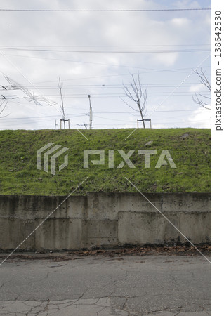 A roadside slope covered with green grass. A roadside slope covered with green grass. 138642530