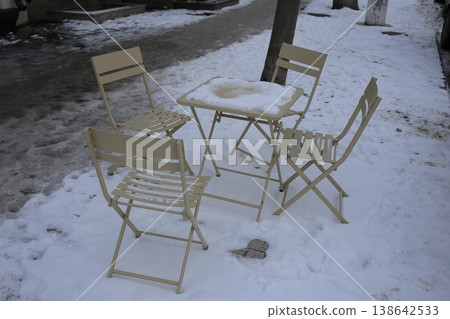 Snow covered closed outdoor cafe. 138642533