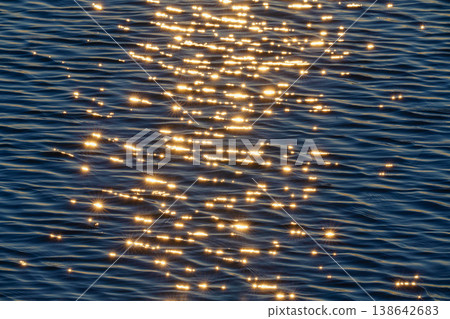 A beautiful abstract seascape created by light reflecting on the water's surface and waves. 138642683