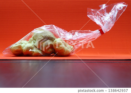 Mini croissants in a plastic bag. 138642937