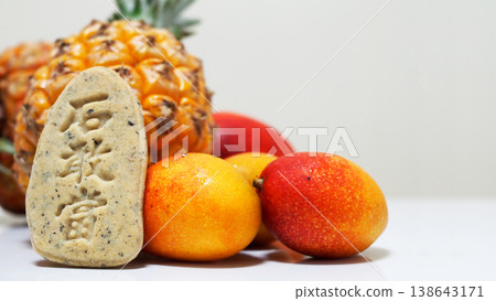 Cookies featuring vibrant Okinawan tropical fruits (mango & pineapple) and Ishiganto (a type of stone marker). Cookies featuring vibrant Okinawan tropical fruits (mango & pineapple) and Ishiganto (a type of stone marker). 138643171