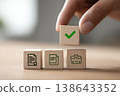 Hand is placing wooden block with green checkmark sign on cubes with file icons. Approval process concept. Decision making, business workflow idea. Paperwork validation symbol. Positive Confirmation 138643352