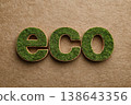 Green grass eco lettering on brown paper background. Nature theme. Green business, bio produce production. Eco simple wooden sign letters in natural setting. Environmental awareness efforts. Flat lay 138643356